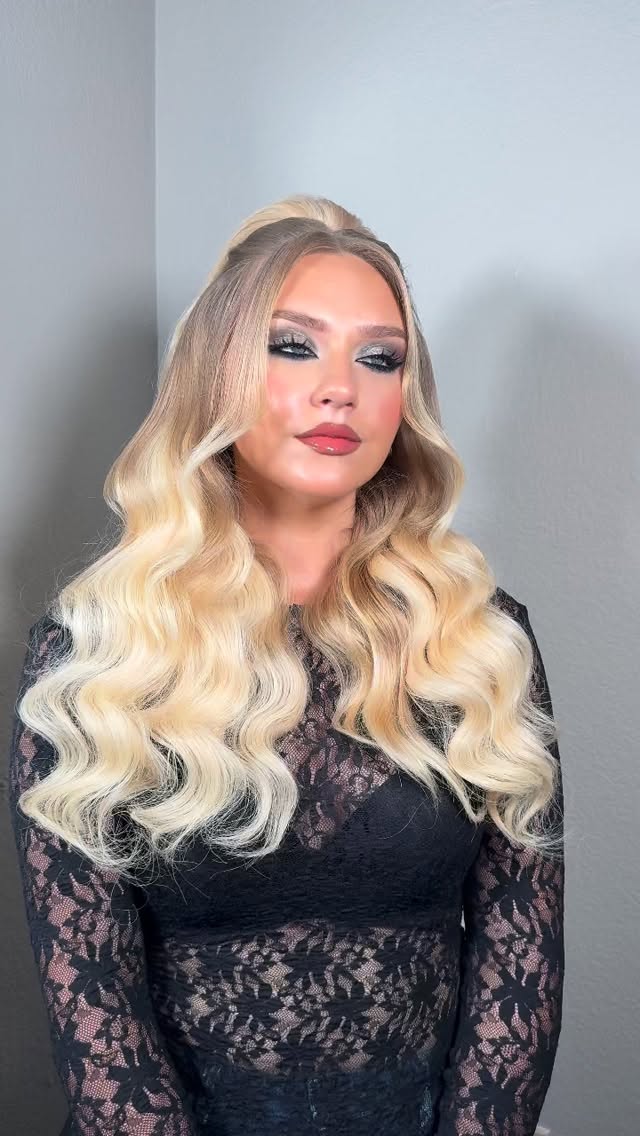 Long blonde hair styled in soft Hollywood waves by Mary